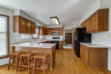 Kitchen featuring hardwood flooring and Corian countertops.  All kitchen appliances stay.