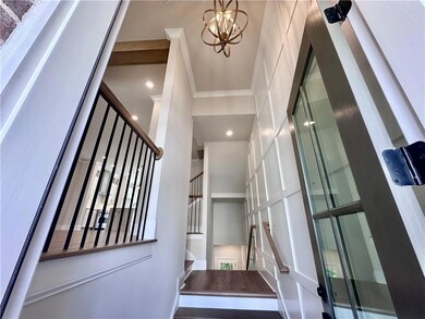 Entry foyer showcases two story wall trim to eleva