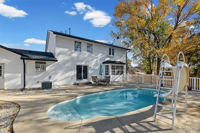 Rear view of house featuring a chimney, a patio, and outdoor dining area
