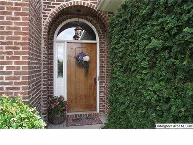 The outside with its arched brick entry, solid woo