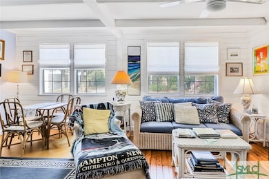 Living room on first level with windows and sunshi