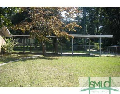 Exterior Back. Carport and backyard
