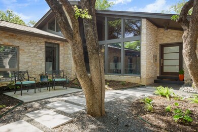 View of exterior entry featuring stone siding, me
