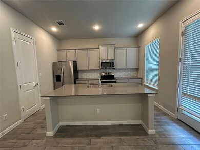 Kitchen featuring appliances with stainless steel