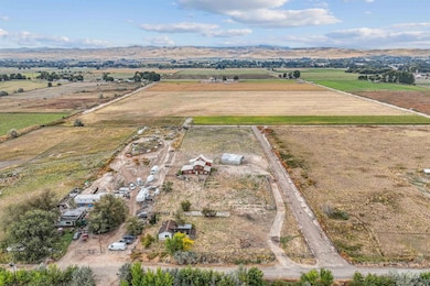 Aerial view of sparsely populated area featuring mountains and farmland