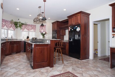 Kitchen has 2 cook tops, wall ovens and microwave.