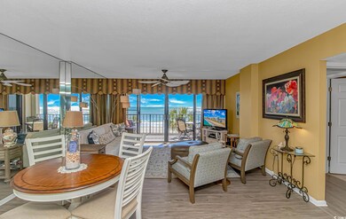 Living room featuring ceiling fan, light wood finished floors, and a textured ceiling
