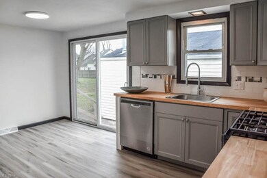 Kitchen has gray cabinetry.