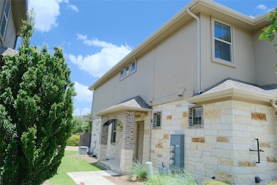 View of side of home featuring stone siding and s