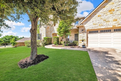 View of front facade featuring a front lawn, ston