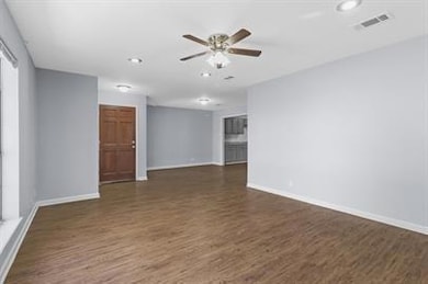 Unfurnished room with dark hardwood / wood-style f