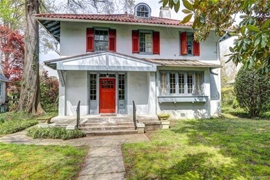 Oversized front stoop offers views of the mature magnolia and front yard.