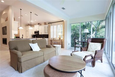 Living room featuring crown molding and light tile