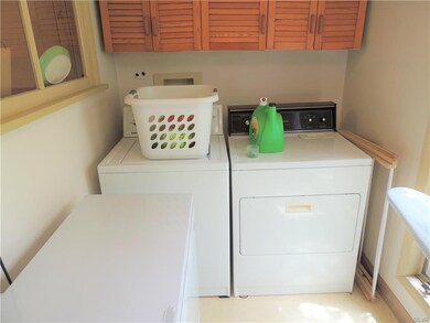 Laundry Room with appliances and storage above.