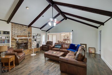 Living room featuring a fireplace, dark hardwood /