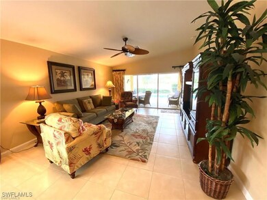 Living room with ceiling fan, light tile patterned