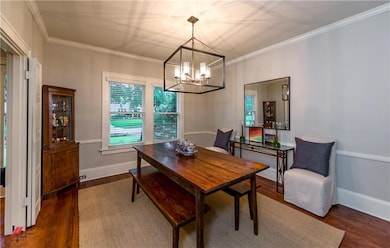 Spacious dining room has unique lighting, crown mo