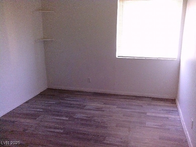 Unfurnished room with dark wood-style floors and baseboards