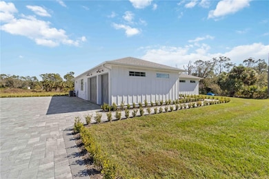 Picture framed paver driveway with radius turns complemented by a permitter hedge lead you to your walkway.