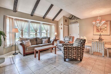 Tiled living room featuring a textured ceiling, va