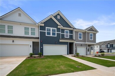 Craftsman-style house featuring board and batten siding, concrete driveway, a front lawn, and a garage