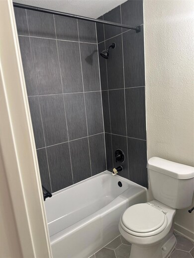Bathroom with tile patterned flooring and shower 