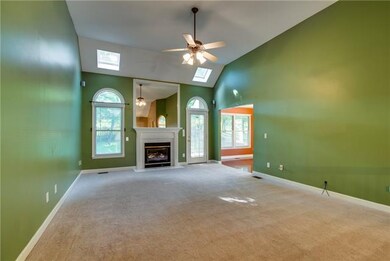 JUST UP THE STAIRS IS THE MASSIVE LIVING ROOM. LUSH CARPETING, GAS FIREPLACE, AND SKYLIGHTS COMPLETE THIS SPACE.