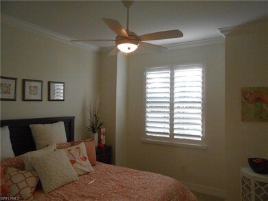 Bedroom featuring ceiling fan and ornamental moldi