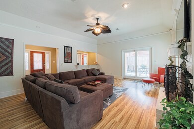 Spacious living area featuring a warm fireplace, with views of the inviting pool through elegant patio doors.