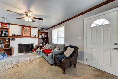 Living room featuring crown molding, light carpet,