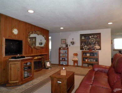 Living Room feature knotty pine wall with brick wo