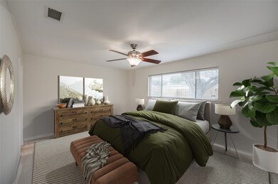 Spacious Primary Bedroom has plenty of space for king size bed and large furniture pieces. Door on left leads to Primary Bath and there are dual walk-in closets! Window overlooks gorgeous tree in backyard. HOME SOLD AS-IS. SELLER WILL DO NO REPAIRS OR CONCESSIONS. PHOTO VIRTUALLY STAGED.