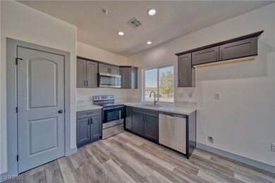 The kitchen features stainless steel appliance pac