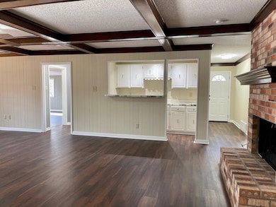 Brick fireplace, dark floors, new paint