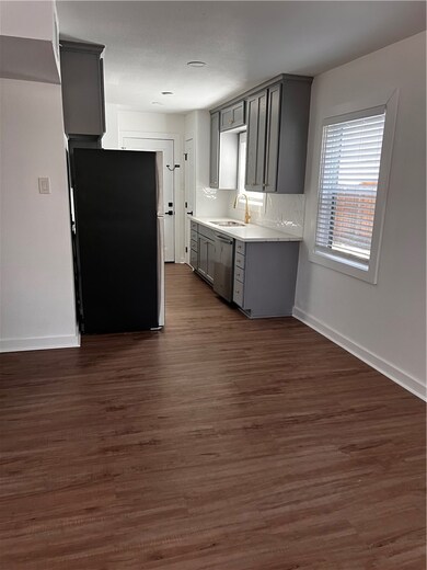 Kitchen featuring dark wood-style flooring, refrig