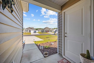 Property entrance featuring a residential view and a lawn