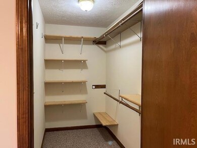 Large Walk-in Closet master Bedroom with shelving and expansive rods