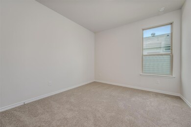 Unfurnished room with light colored carpet and vau