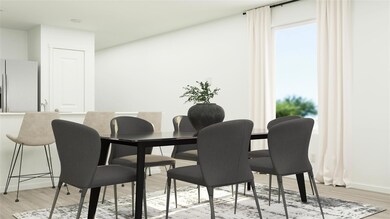 Dining space with light wood-style flooring and ba