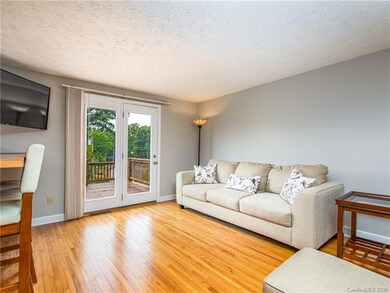 Main level living room connects to kitchen through