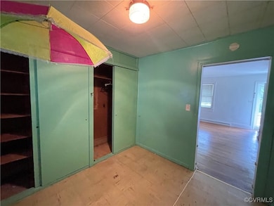 Unfurnished bedroom with a baseboard radiator and