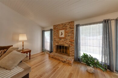 Beautiful brick fireplace surrounded by windows an