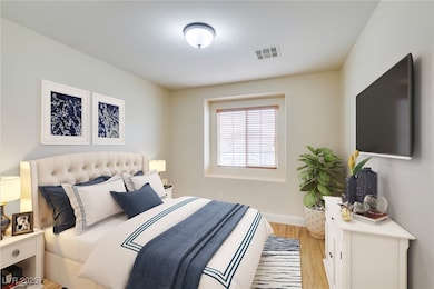 Bedroom featuring light wood finished floors and b