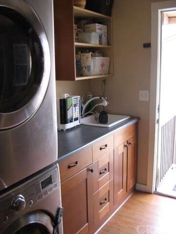 Large laundry room w/door leading to backyard
