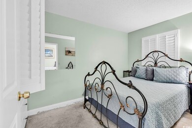 Bedroom featuring baseboards, carpet floors, and a