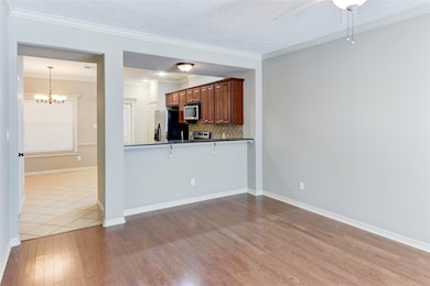 Kitchen featuring refrigerator with ice dispenser,