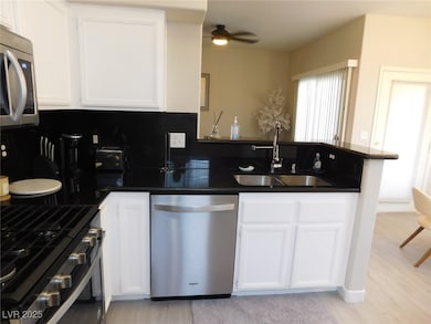 Kitchen with stainless steel appliances, a sink, d