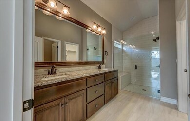 Large zero-entry tiled master shower with dual sho