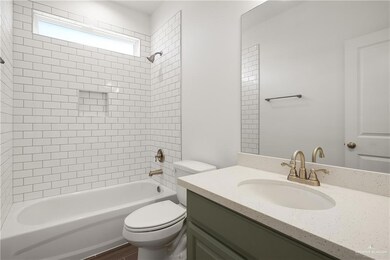 Bathroom featuring toilet, shower / bath combination, and vanity