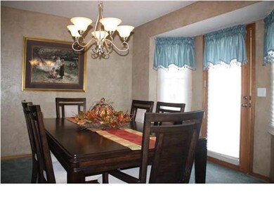 Dining area open to living room. Door leads out to